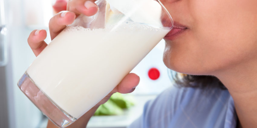 Close-up Of A Woman Drinking Glass Of Fresh Milk